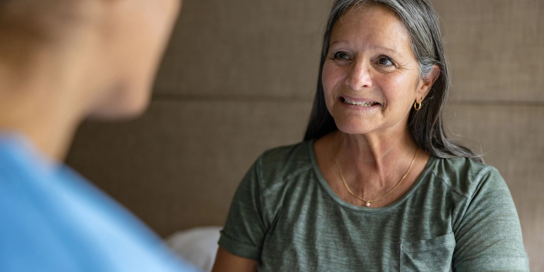 Doctor speaking attentively with an adult patient in a bright clinic room
